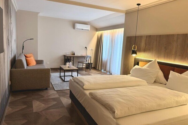 Premium bedding, desk, laptop workspace, blackout drapes