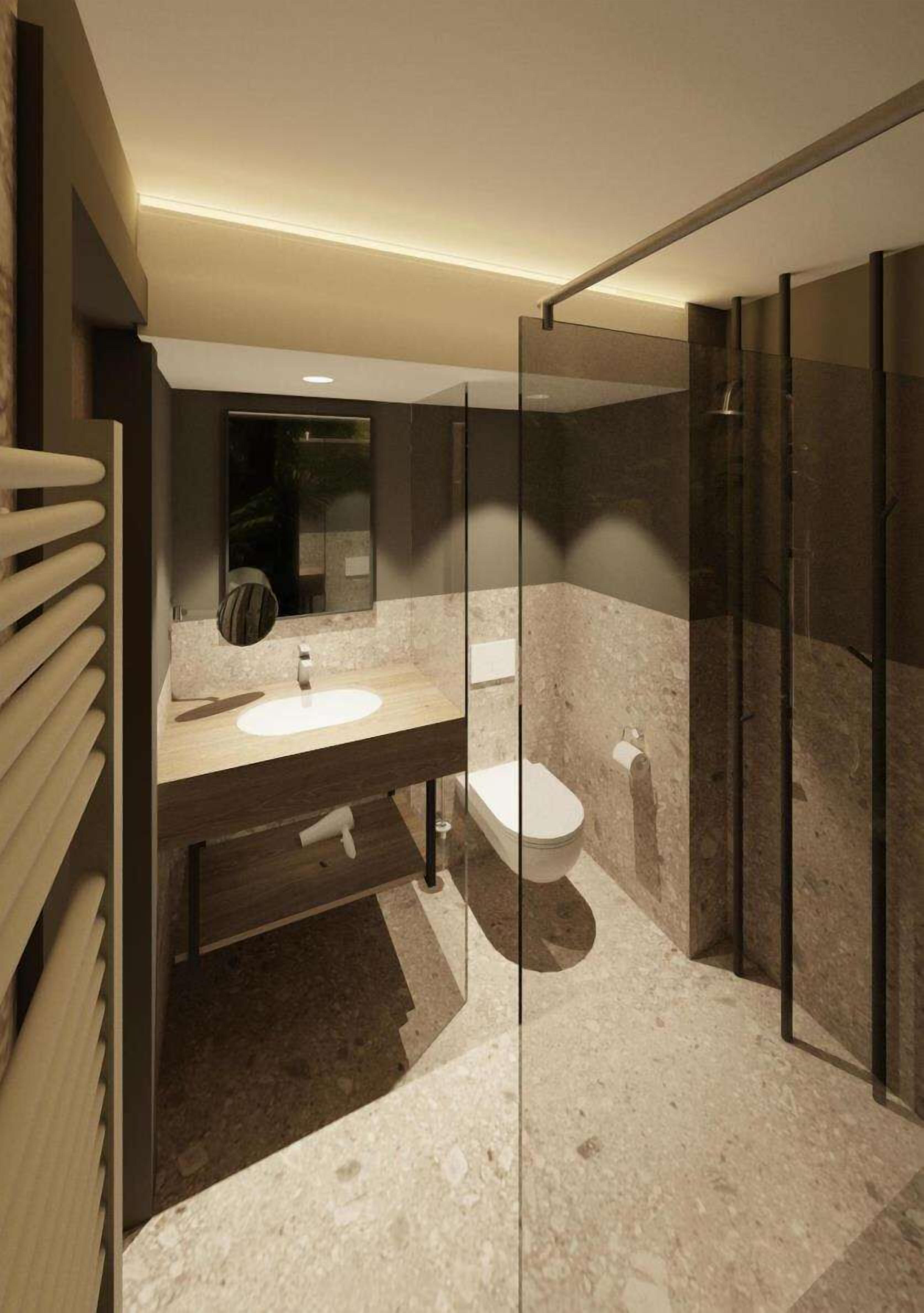 A modern bathroom with a glass-enclosed shower, a sink with a mirror, and a toilet.