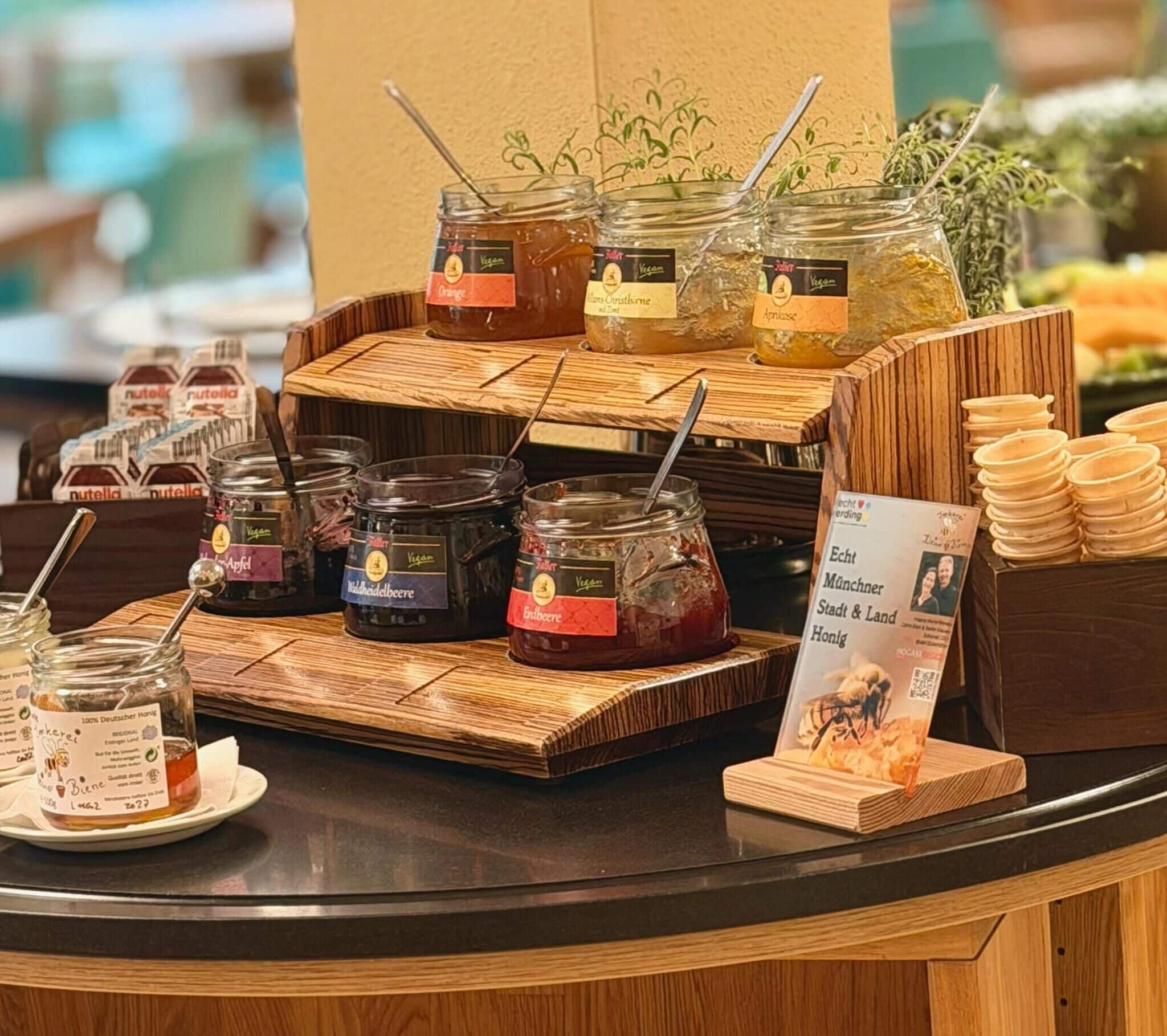 A counter with various jars of condiments and a signboard.