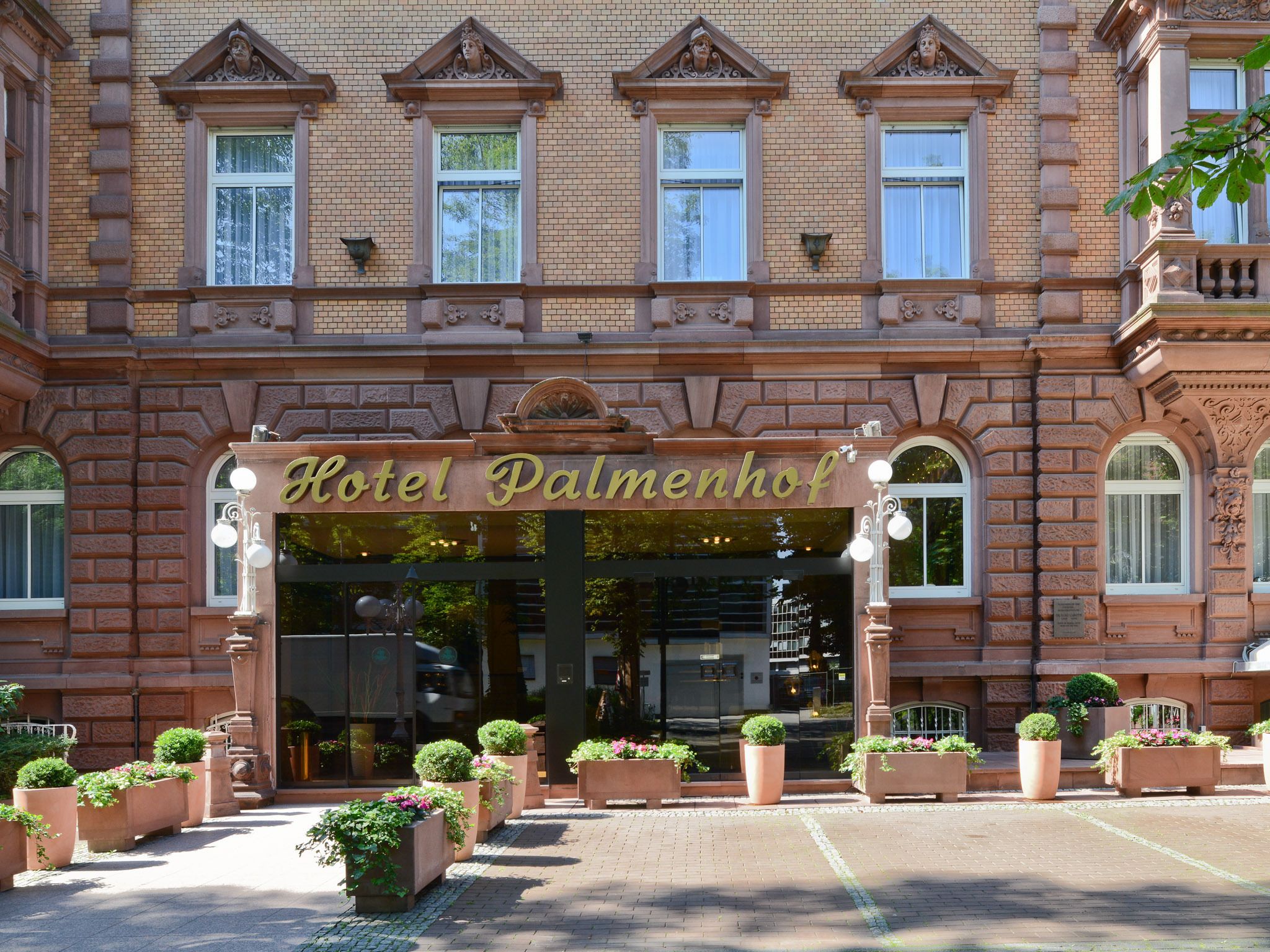 A historic building with a sign reading "Hotel Palmenhof".