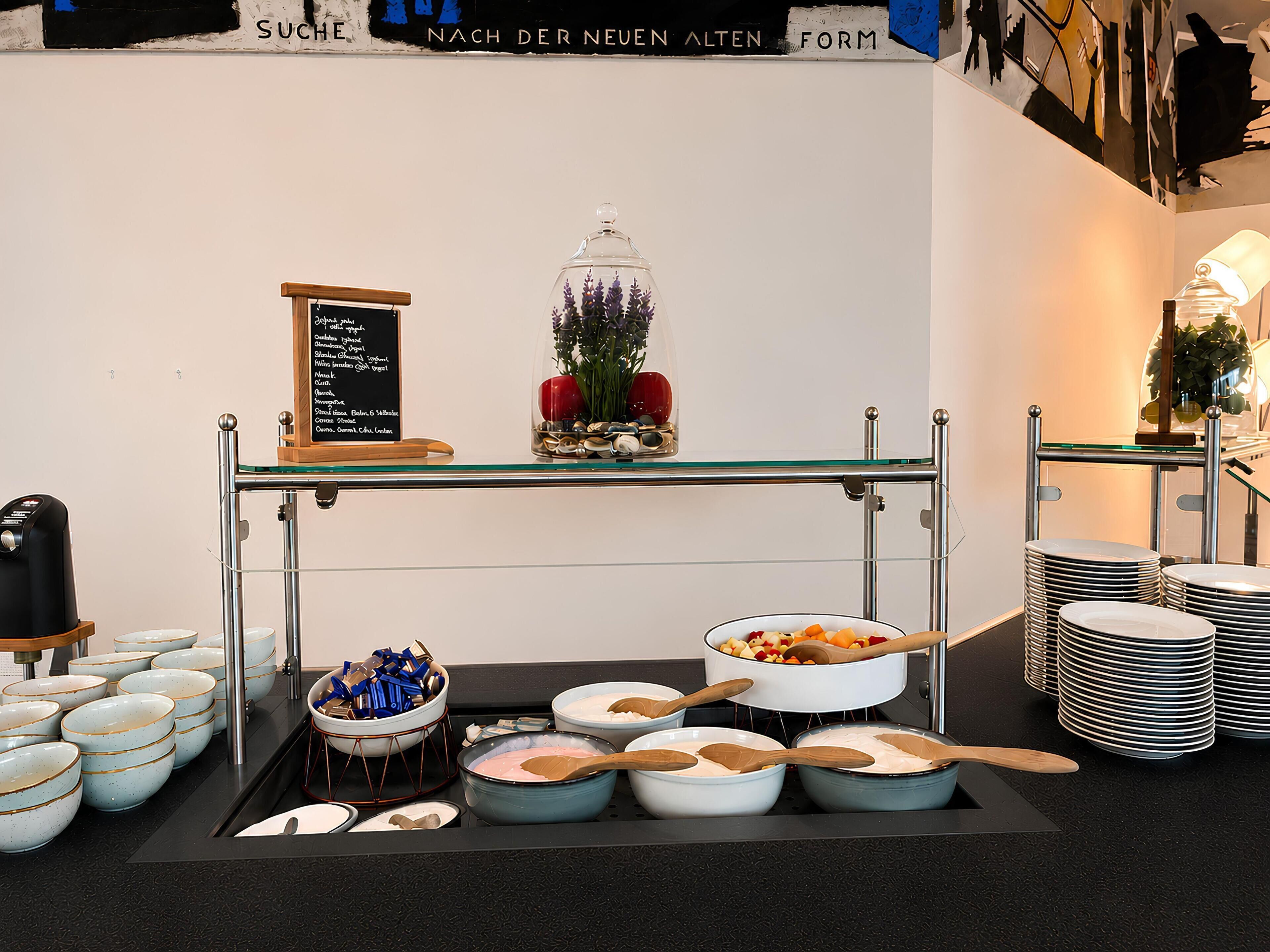 A buffet setup with various food items and utensils.