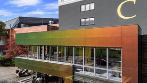 Un hotel de diseño moderno, con un amplio ventanal de vidrio y techo plano.