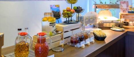 A breakfast buffet with various food items and condiments.