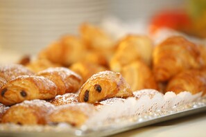 A tray of pastries dusted with powdered sugar.