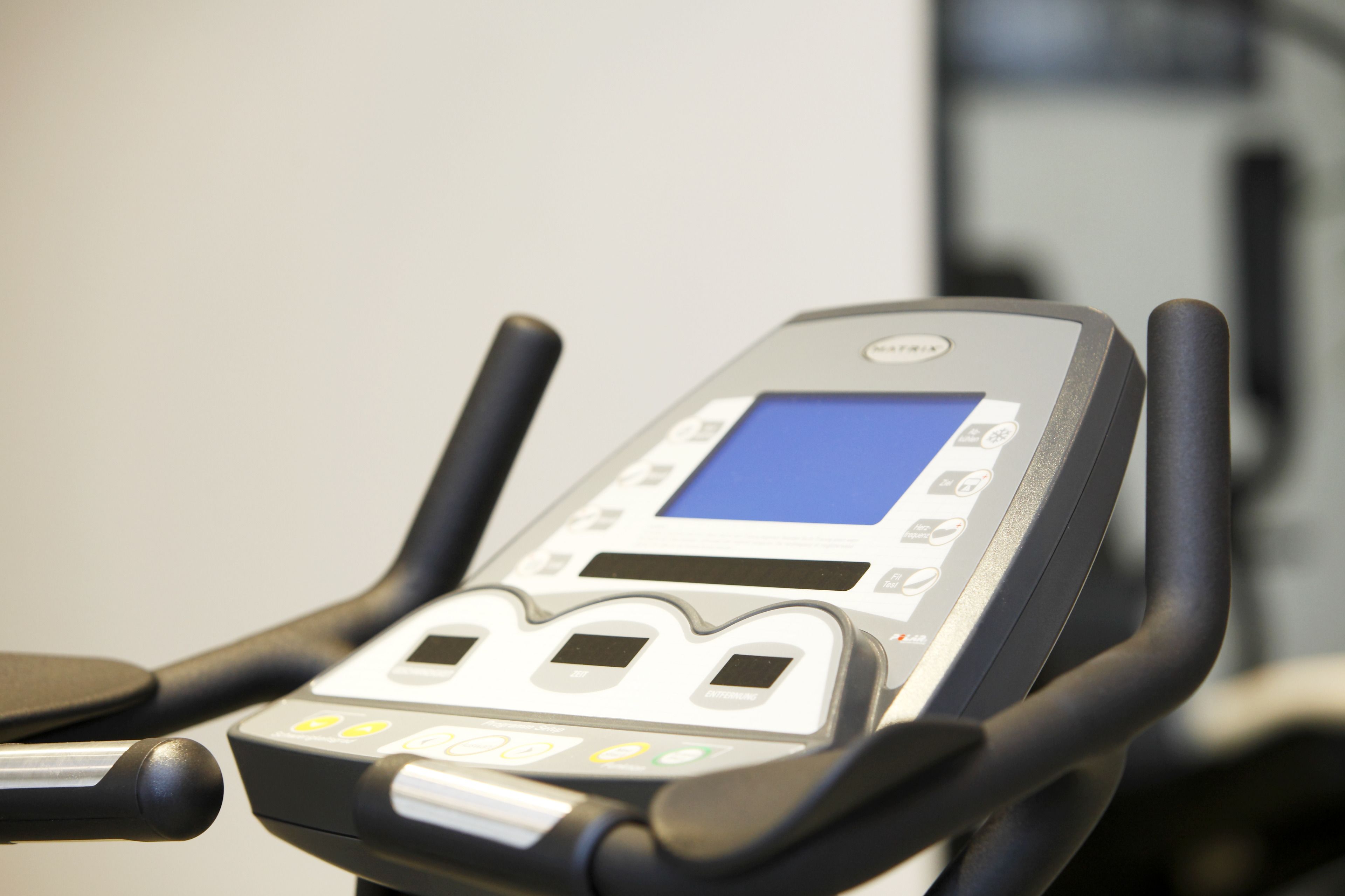 A stationary exercise bike with a digital display and control panel.
