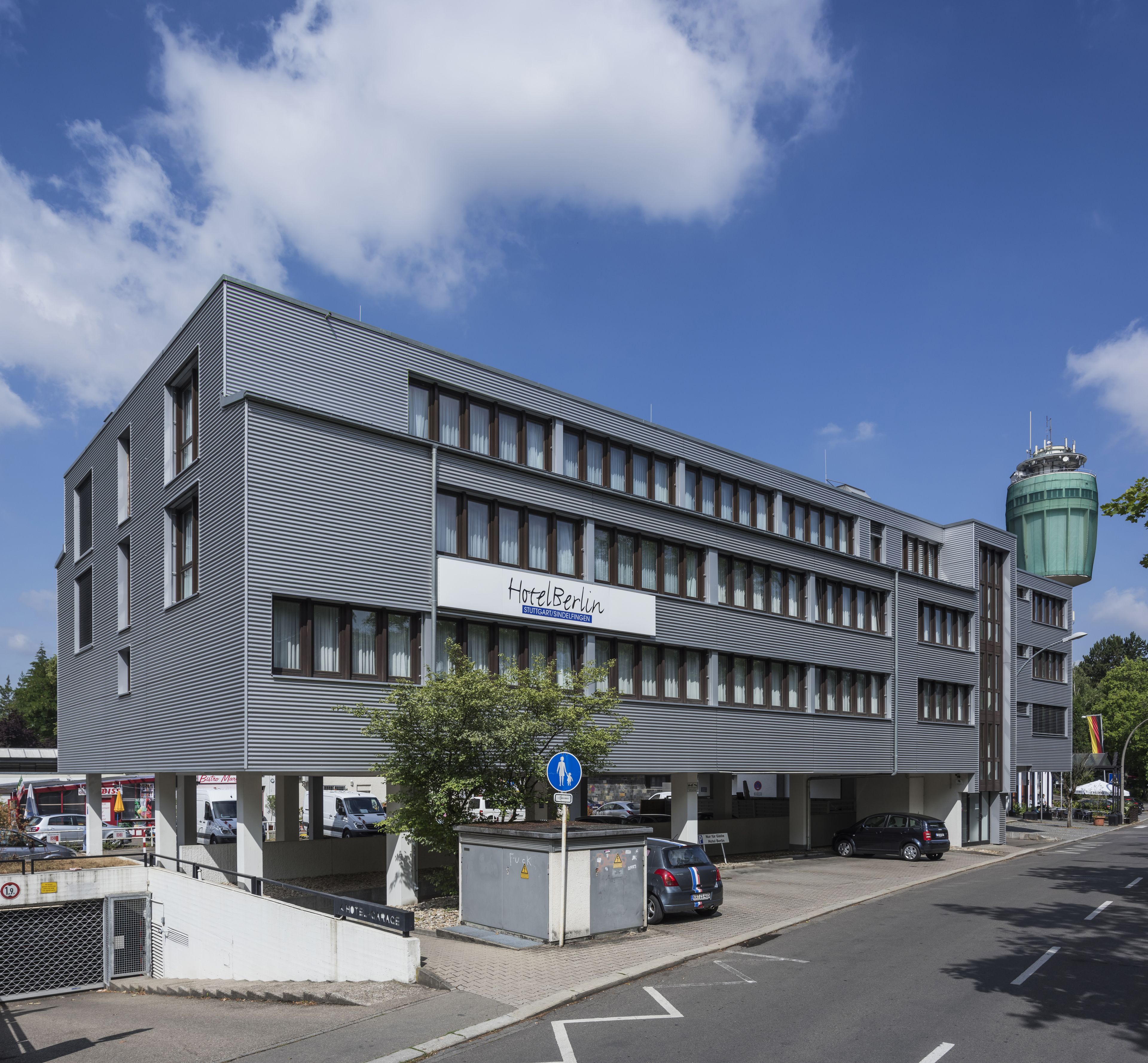 A modern hotel building with a sign reading "Hotel Berlin."