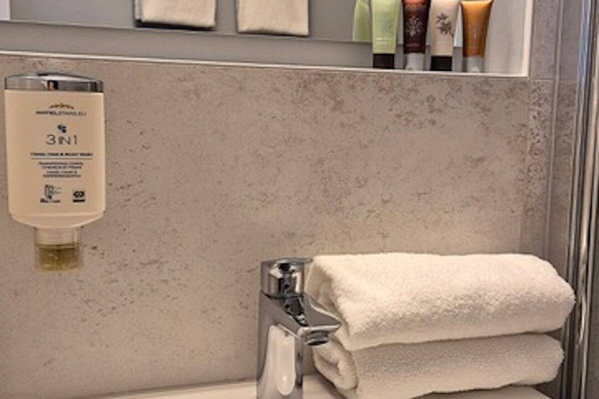 senior suite | bathroom | shower, hair dryer, towels