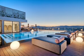Una piscina al aire libre, una piscina climatizada, sombrillas, tumbonas