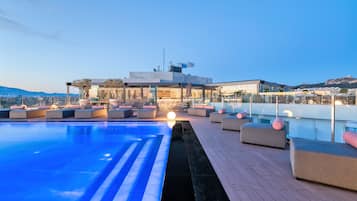 Outdoor pool, a heated pool, open 9:00 AM to 8:00 PM, pool umbrellas