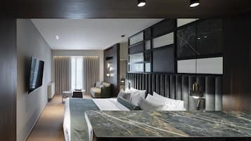 Una camera d'albergo moderna con un letto grande, una TV a parete, un’area salotto con divano e poltrone, e un’ampia finestra con tende.