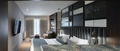 A modern hotel room with a large bed, a TV mounted on the wall, a seating area with a sofa and armchairs, and a large window with curtains.