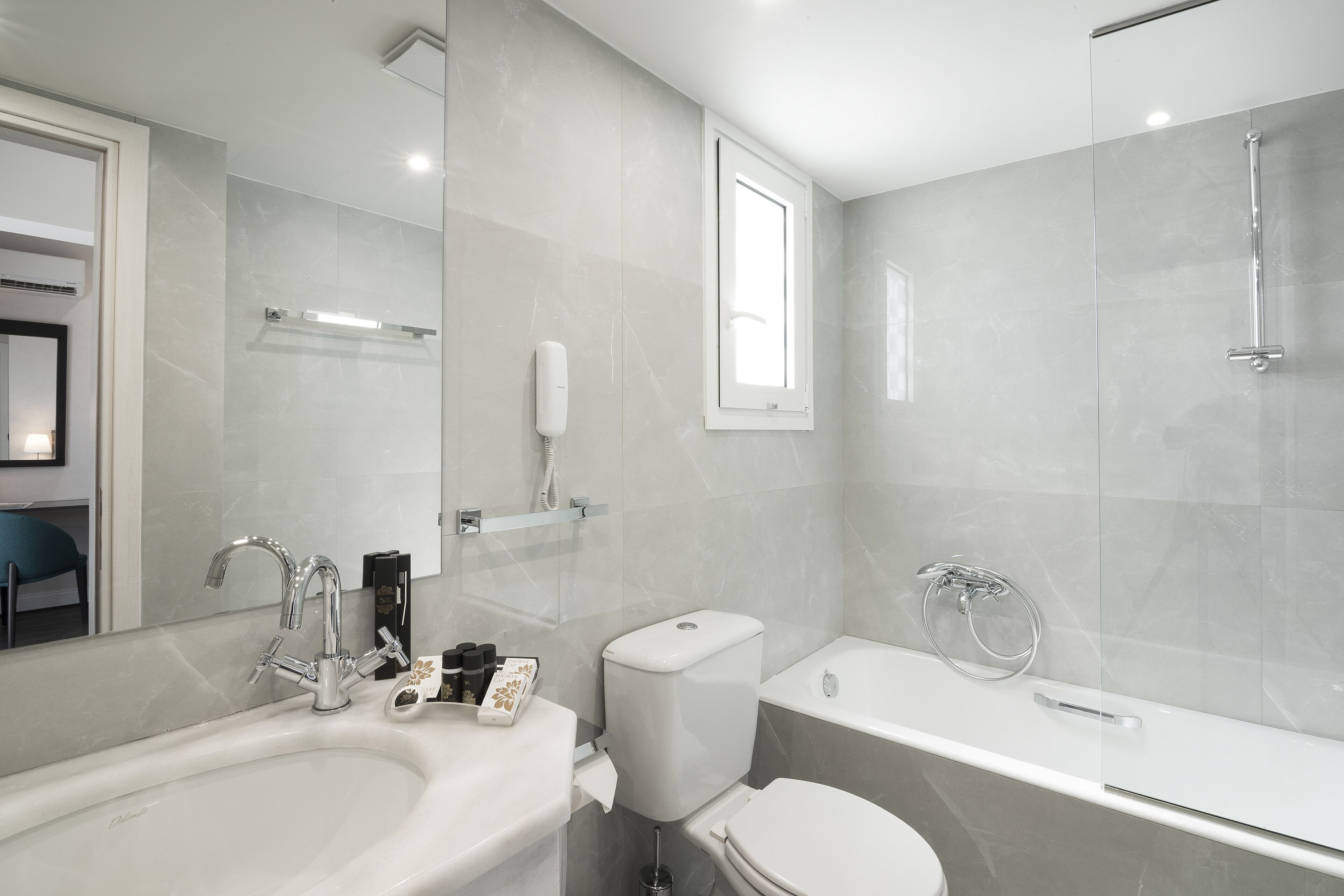 A modern bathroom with a bathtub, toilet, and sink.