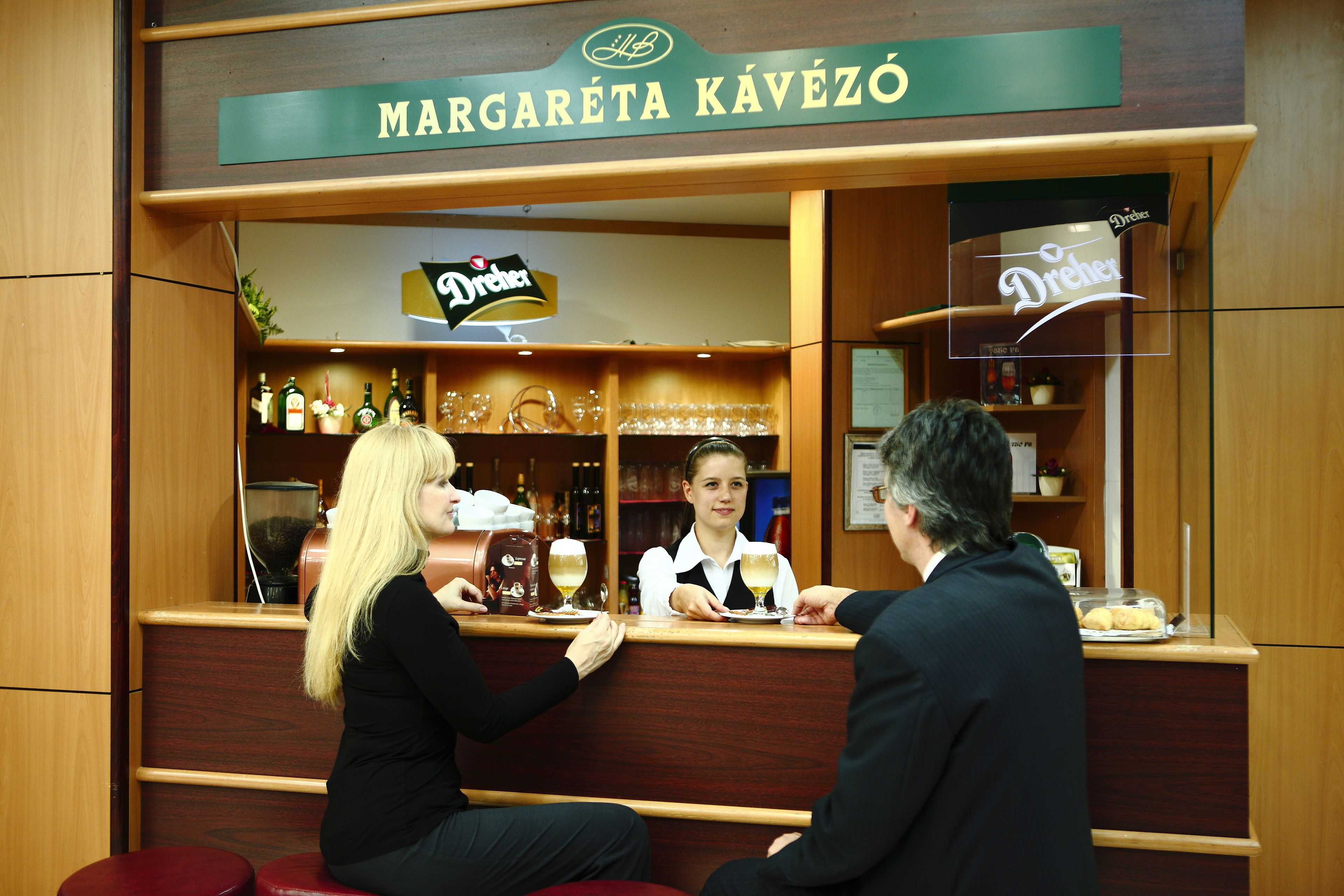 A bar with a sign reading "Margaréta Kávezó" and a logo for "Drinka".