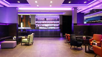 A bar area with seating and a liquor display.
