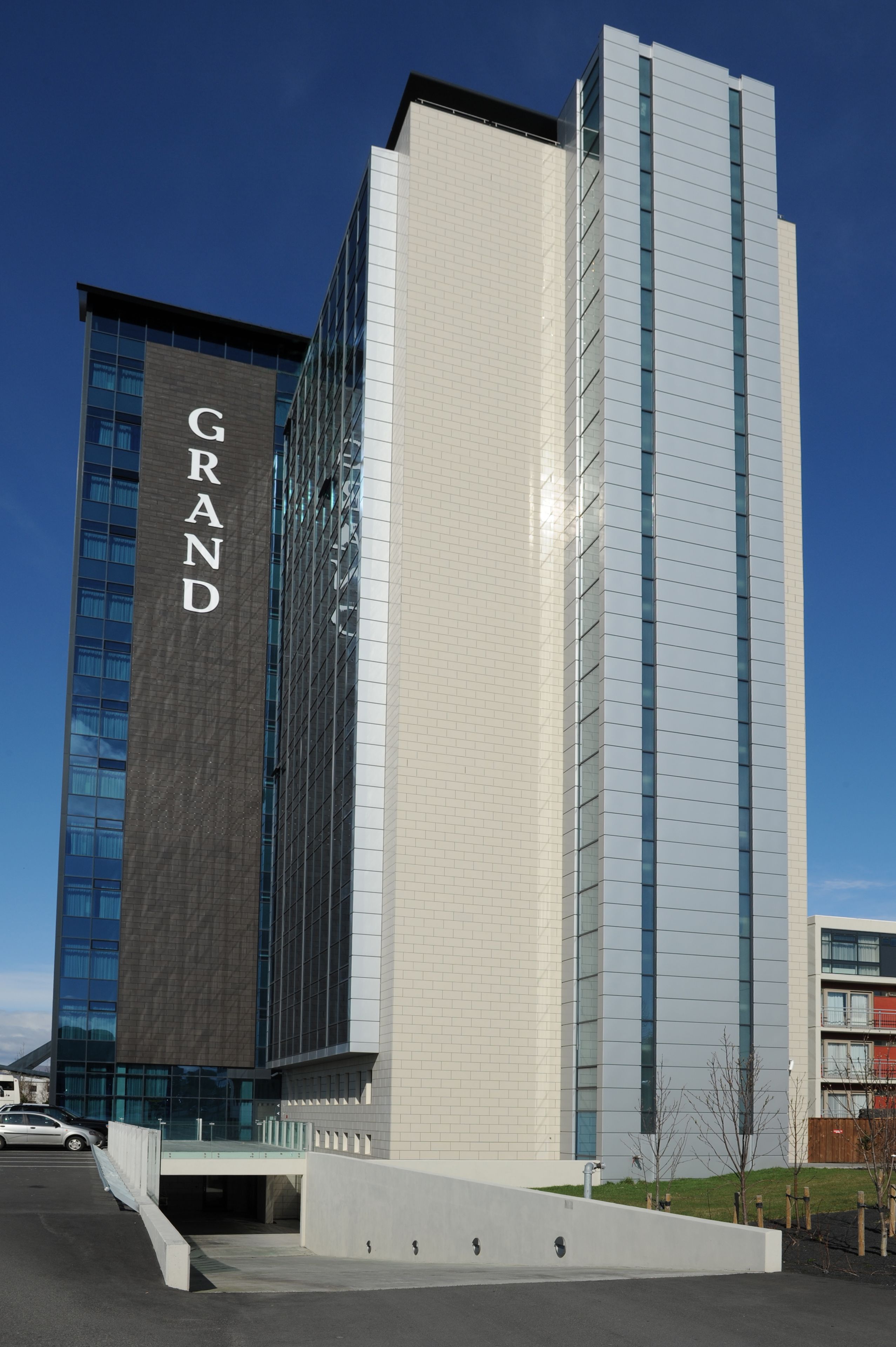 A modern building with a prominent 'GRAND' sign on its facade.