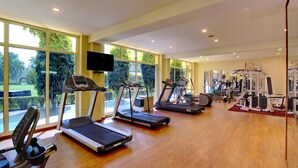 A gym with treadmills, elliptical machines, and weight equipment. - Hotel Clarks Shiraz (Agra)