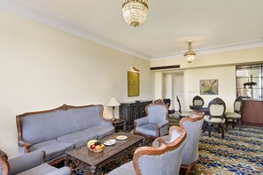 Presidential Studio Suite | Living area | 29-inch LCD TV with satellite channels, TV - Cama Hotel (Ahmedabad)