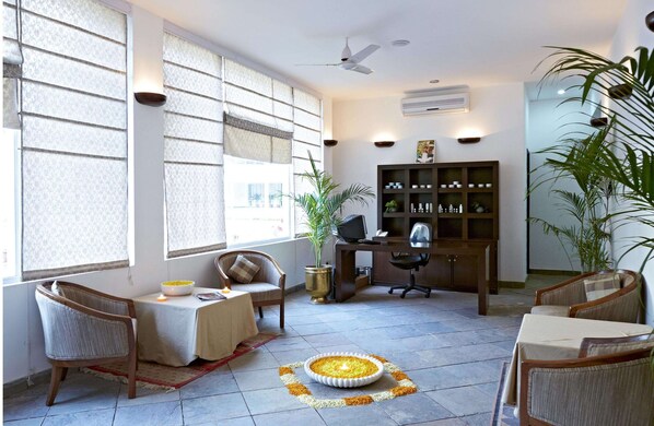 A room with a desk, chair, and a decorative floor pattern.