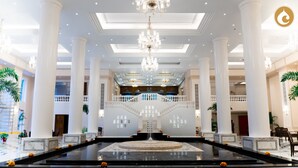 A grand lobby with a central fountain, high ceilings, and classical columns. - Clarks Avadh, Lucknow (Lucknow)