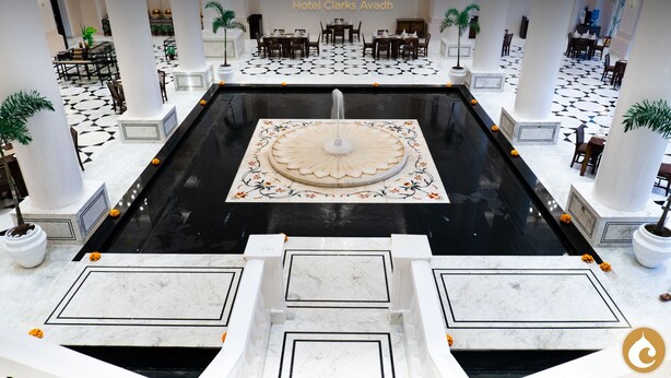 A grand lobby with a central fountain, marble flooring, and multiple seating areas. - Clarks Avadh, Lucknow (Lucknow)
