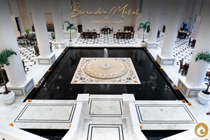 A grand lobby with a central fountain, marble flooring, and multiple seating areas. - Clarks Avadh, Lucknow (Lucknow)