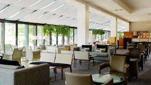 A spacious lobby with multiple seating areas, large windows, and indoor plants. - Herbert Park Hotel (Dublin)