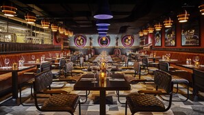 A restaurant with multiple dining tables and booths, each set with wine glasses and cutlery. - The Grafton Hotel (Dublin)