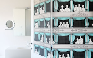 A bathroom with a mirror, a sink, and a towel rack. - Grand Hotel Palace (Ancona)