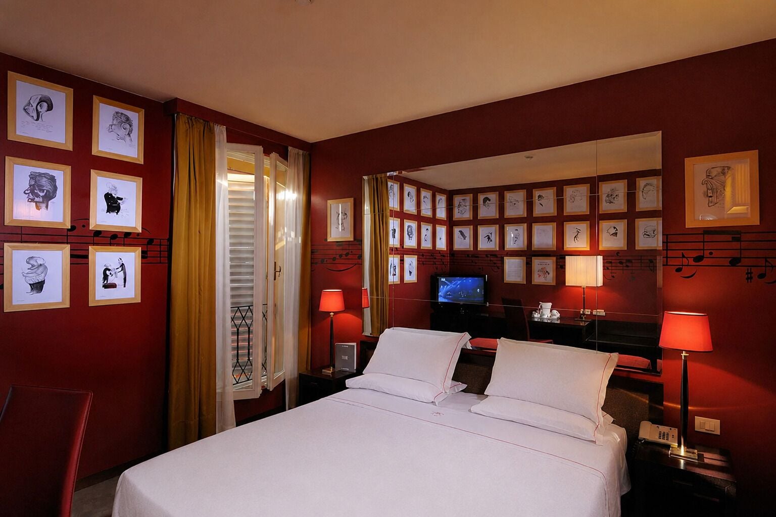 A hotel room with a bed, two bedside tables, a TV, and framed artwork on the walls.