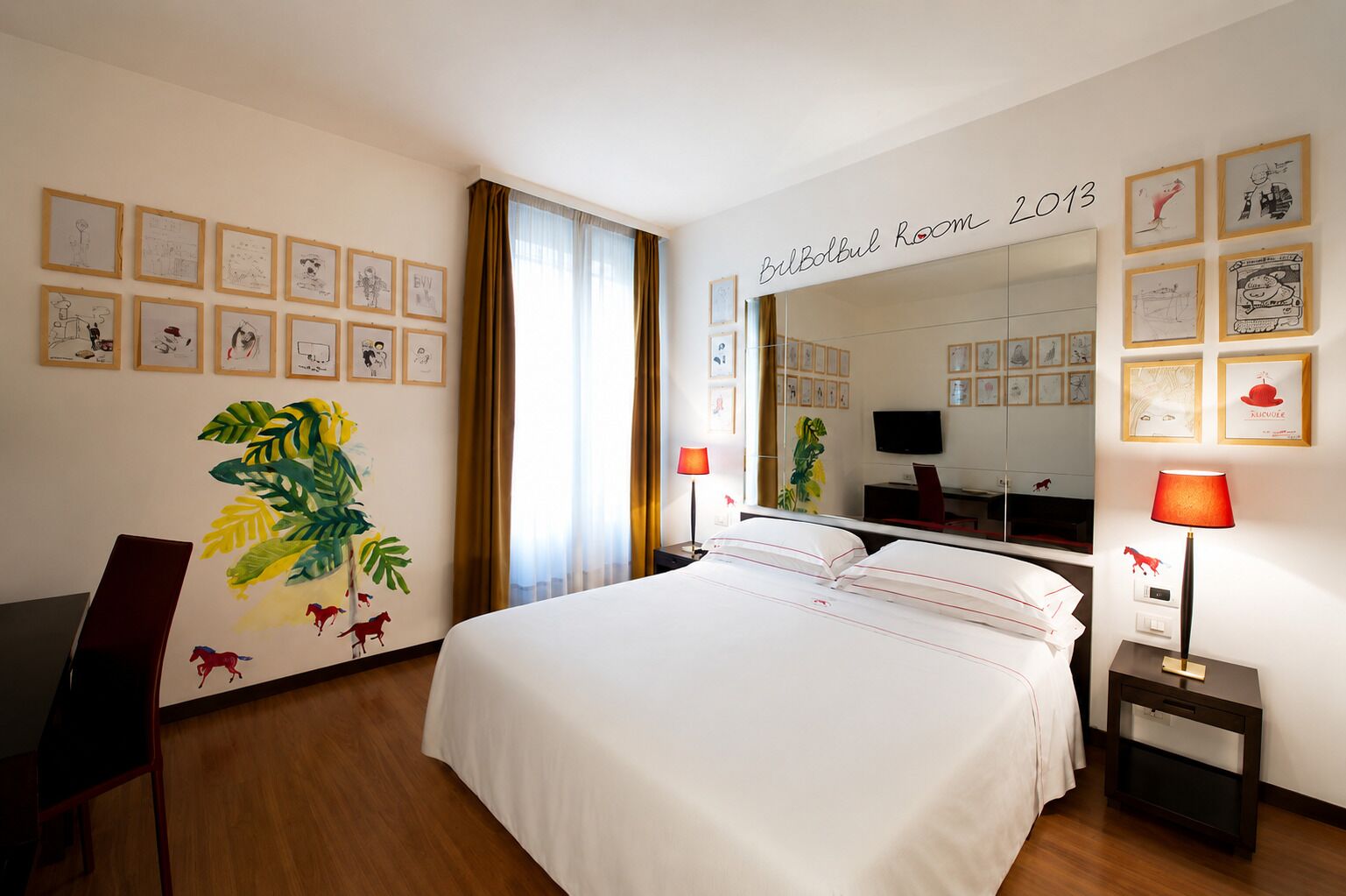 A hotel room with a bed, a desk, a chair, a TV, and a mirror.