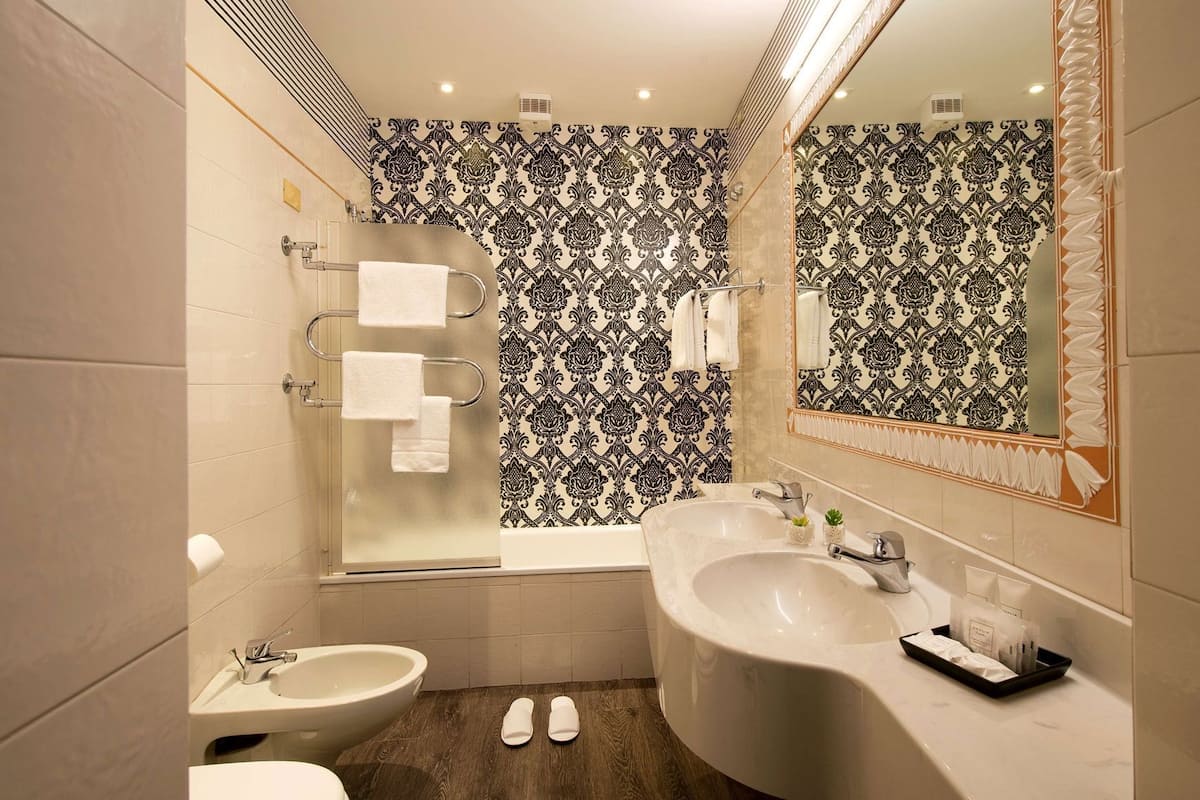 A bathroom with a bathtub, a sink, and a toilet.