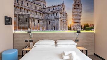 Camera d'albergo con un letto grande, due comodini e una lampada a parete.