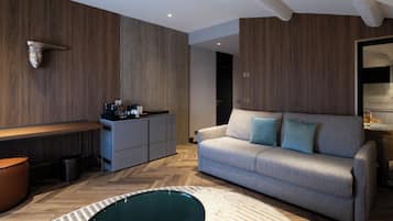 A modern living room with a sofa, a coffee table, and a kitchen area with a countertop.