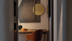 A modern interior with a wooden floor, a desk with a chair, and a wall-mounted TV. - Palazzo 4 Fontane 12 (Rome)