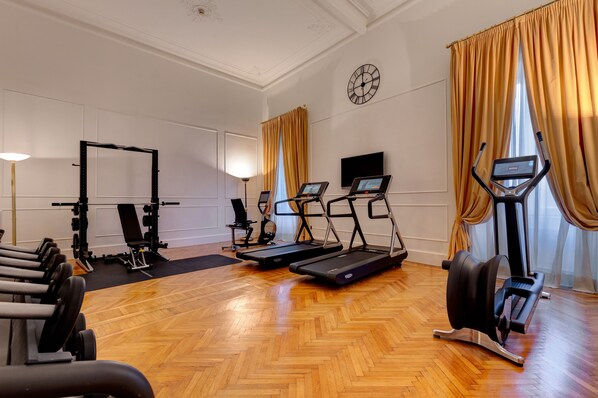 A gym with treadmills, a weight bench, and a stationary bike.