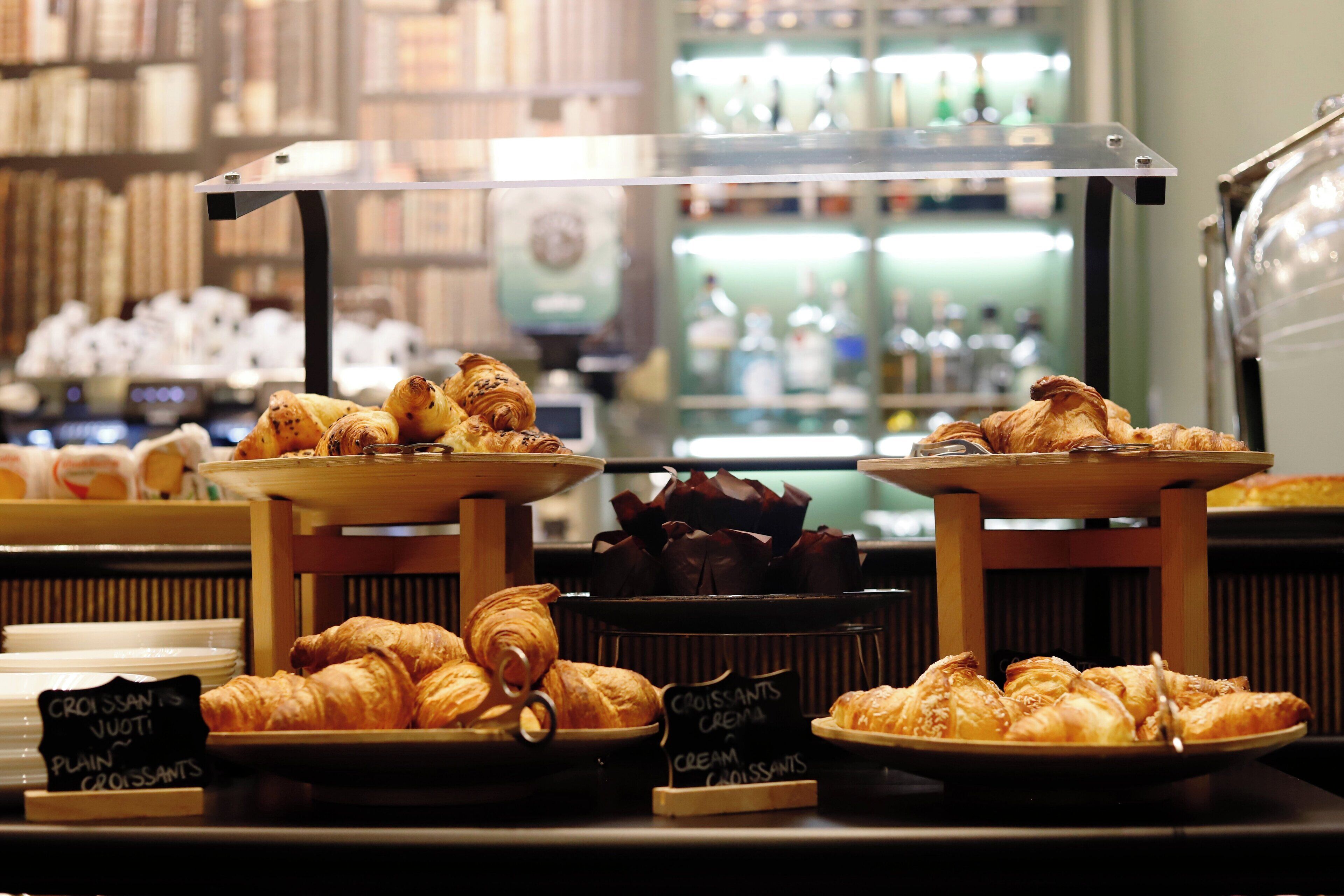 A bakery display with various types of croissants and pastries.