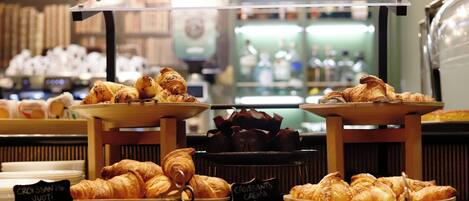 A bakery display with various types of croissants and pastries.
