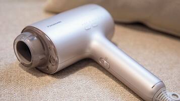 A Panasonic hair dryer on a beige carpet.