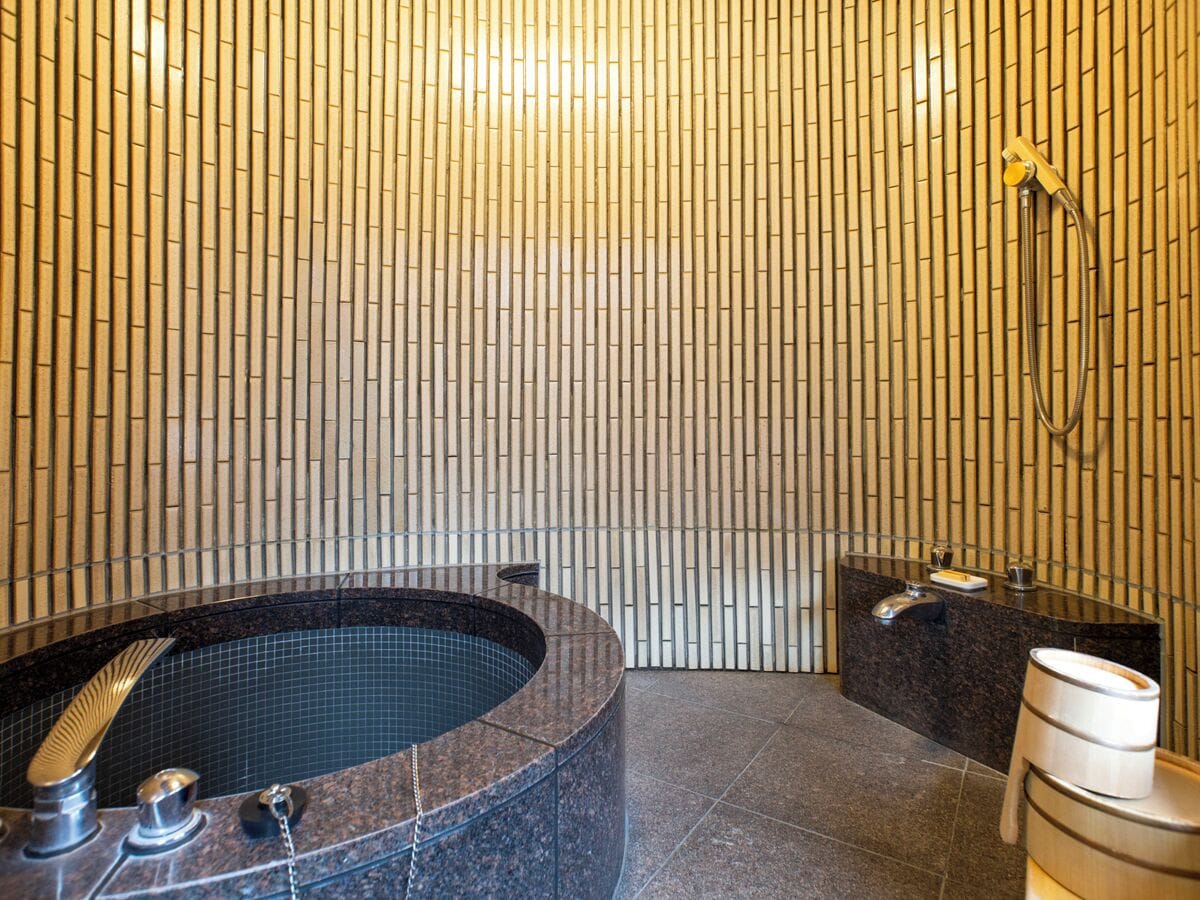 A modern bathroom with a freestanding bathtub, a shower, and a vanity with a mirror.