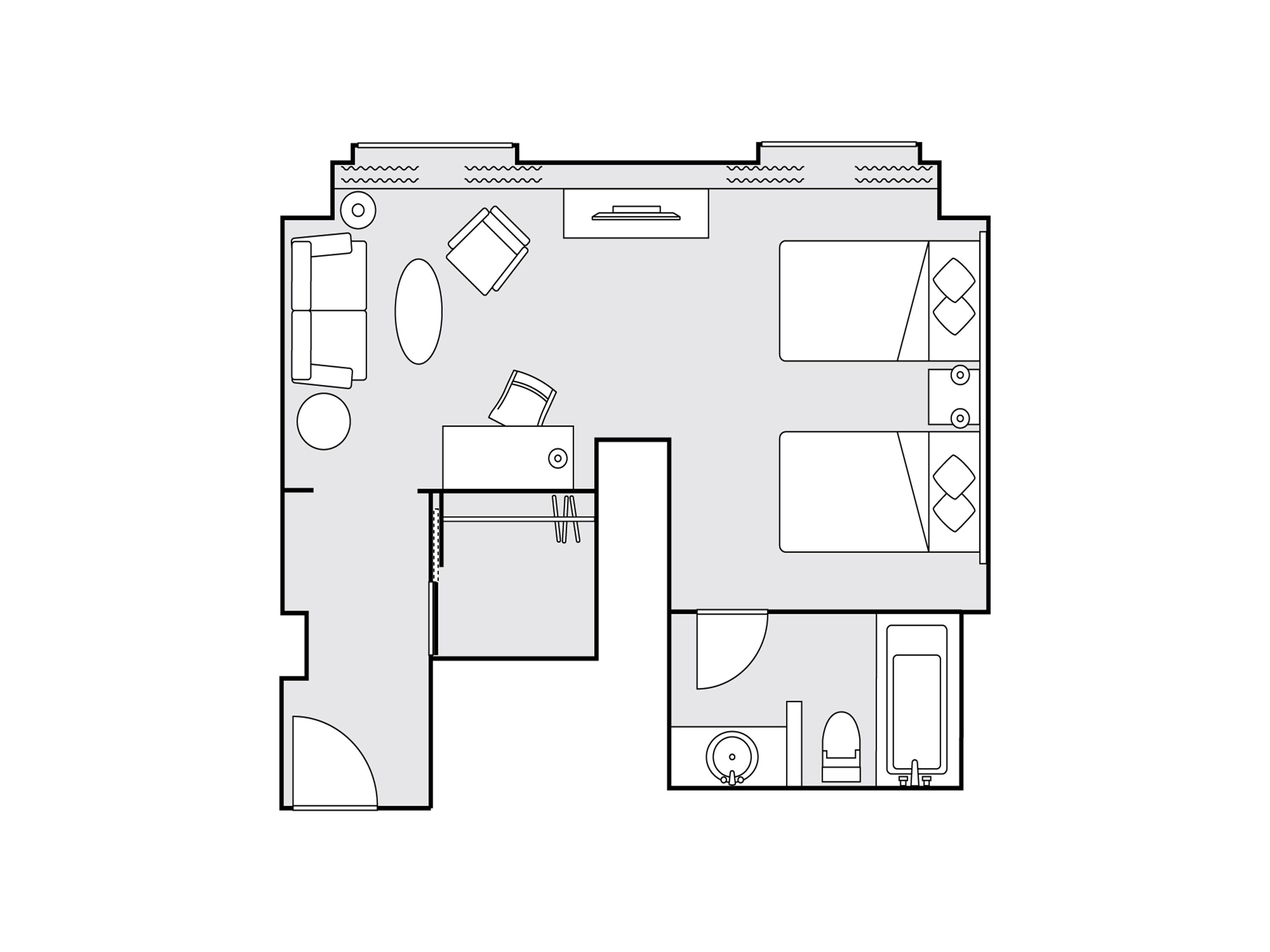 A floor plan of a hotel room with a bed, a desk, a chair, a small table, a sofa, and a bathroom.