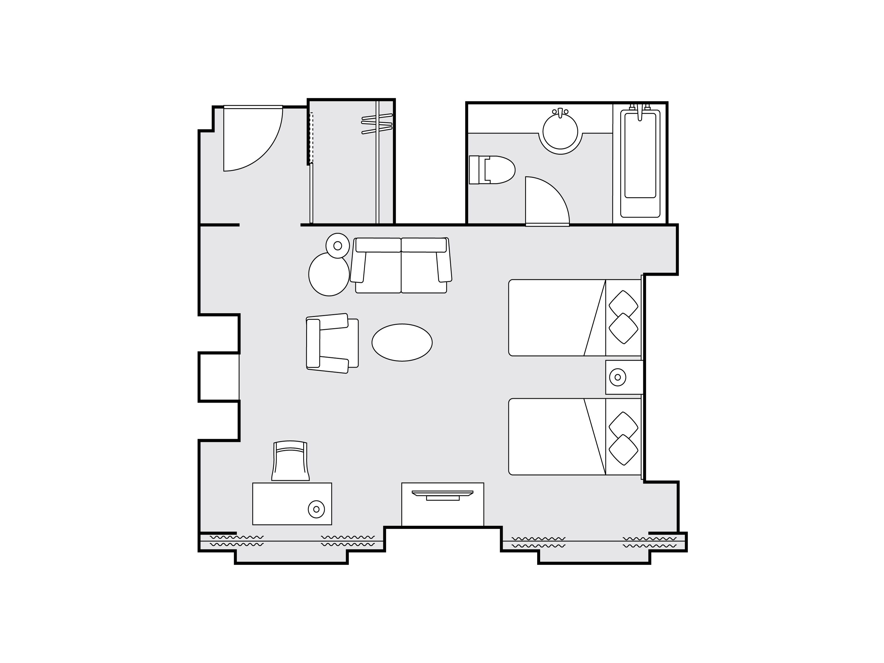 A floor plan of a hotel room with a bed, a desk, a chair, a sofa, a small table, and a bathroom with a toilet and sink.