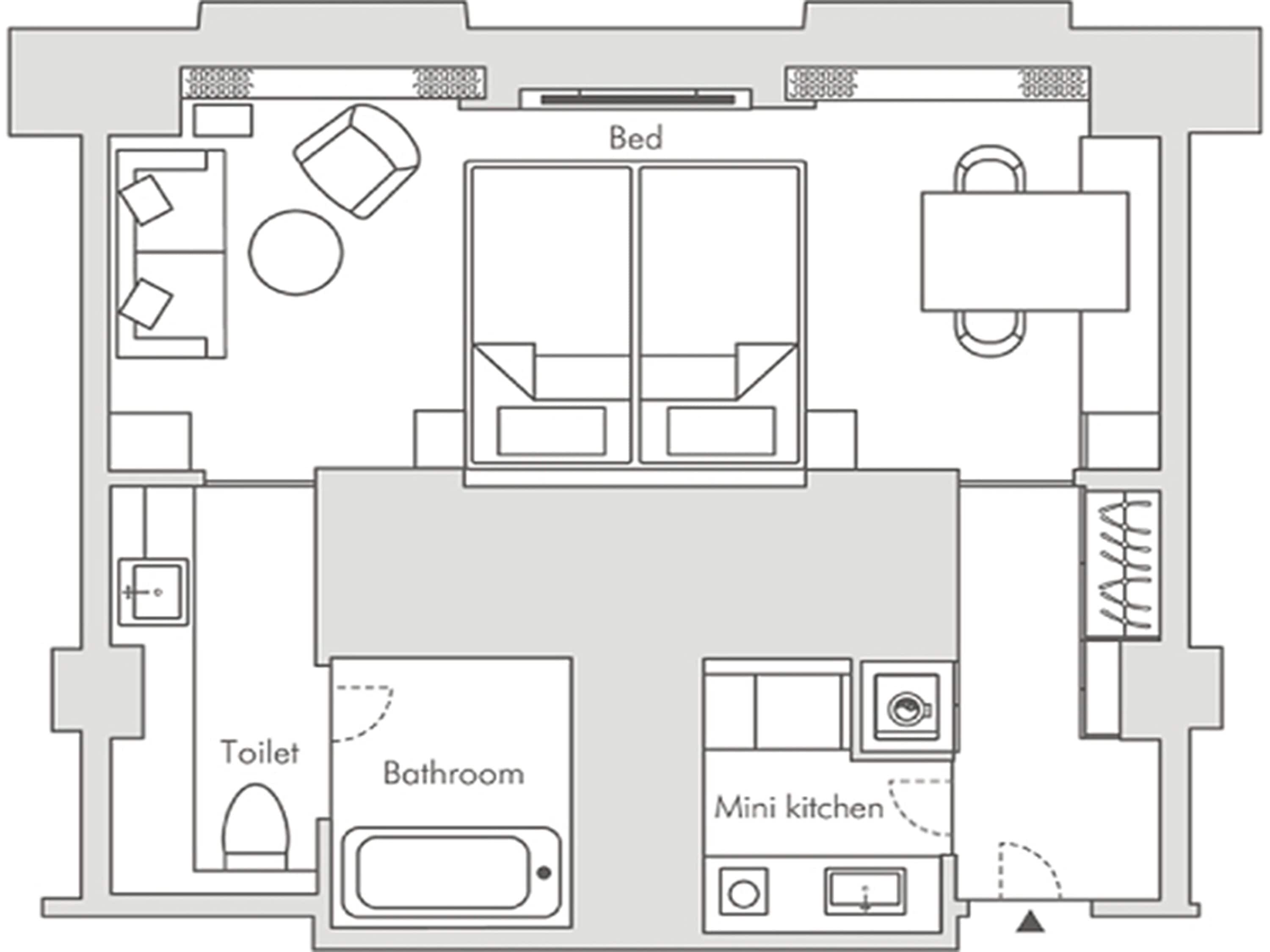 A floor plan with a bed, two bathrooms, a toilet, and a mini kitchen.