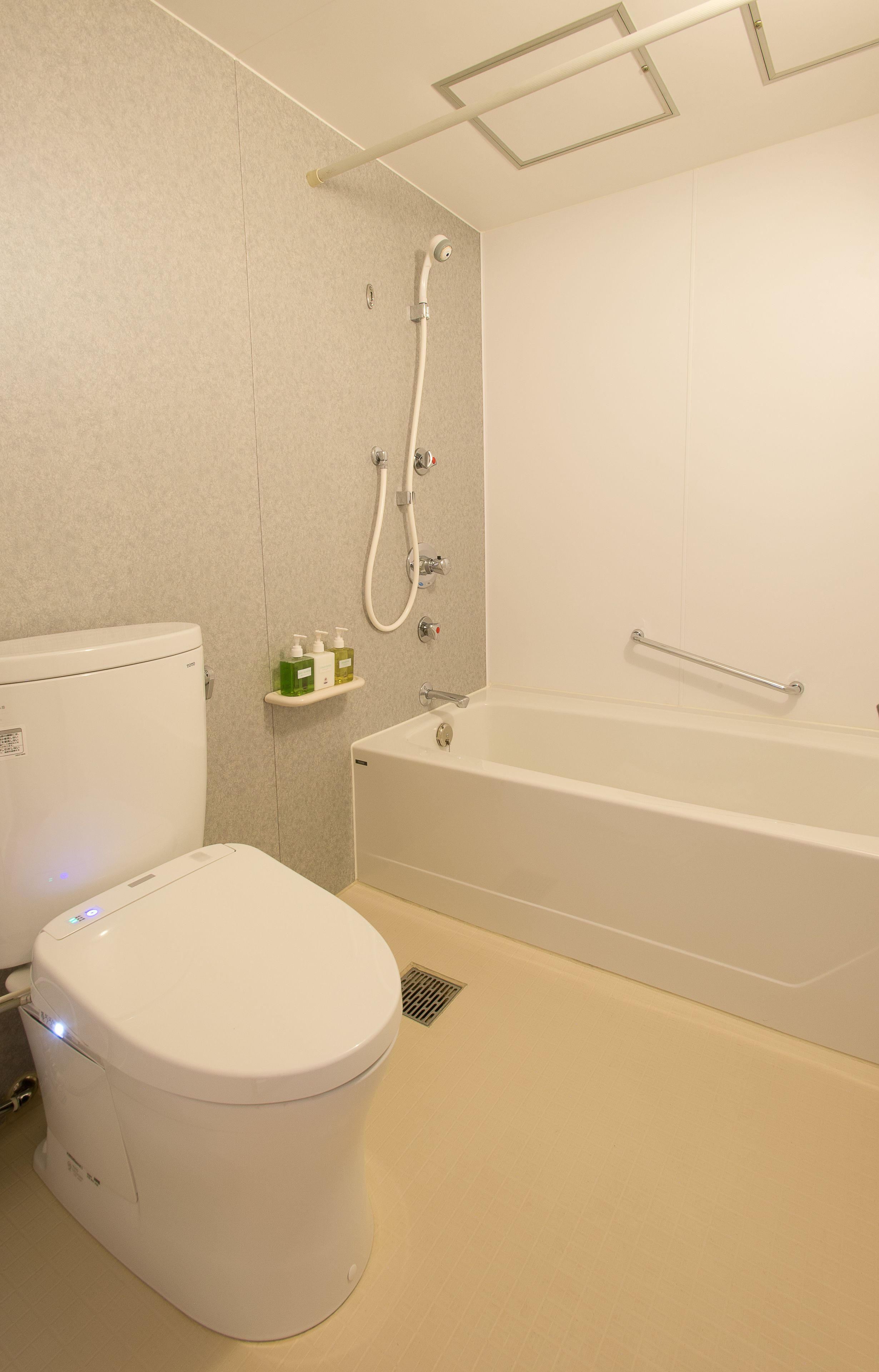 A modern bathroom with a toilet, a shower, and a bathtub.