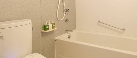 A modern bathroom with a toilet, a shower, and a bathtub.