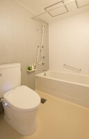 A modern bathroom with a toilet, a shower, and a bathtub.