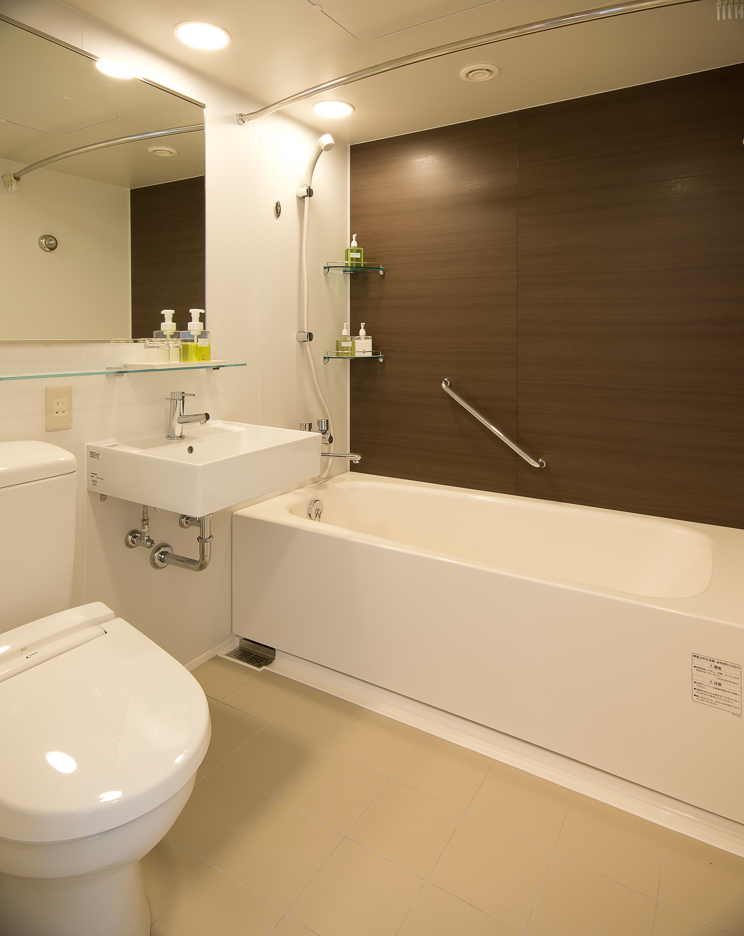 A modern bathroom with a toilet, sink, and bathtub.
