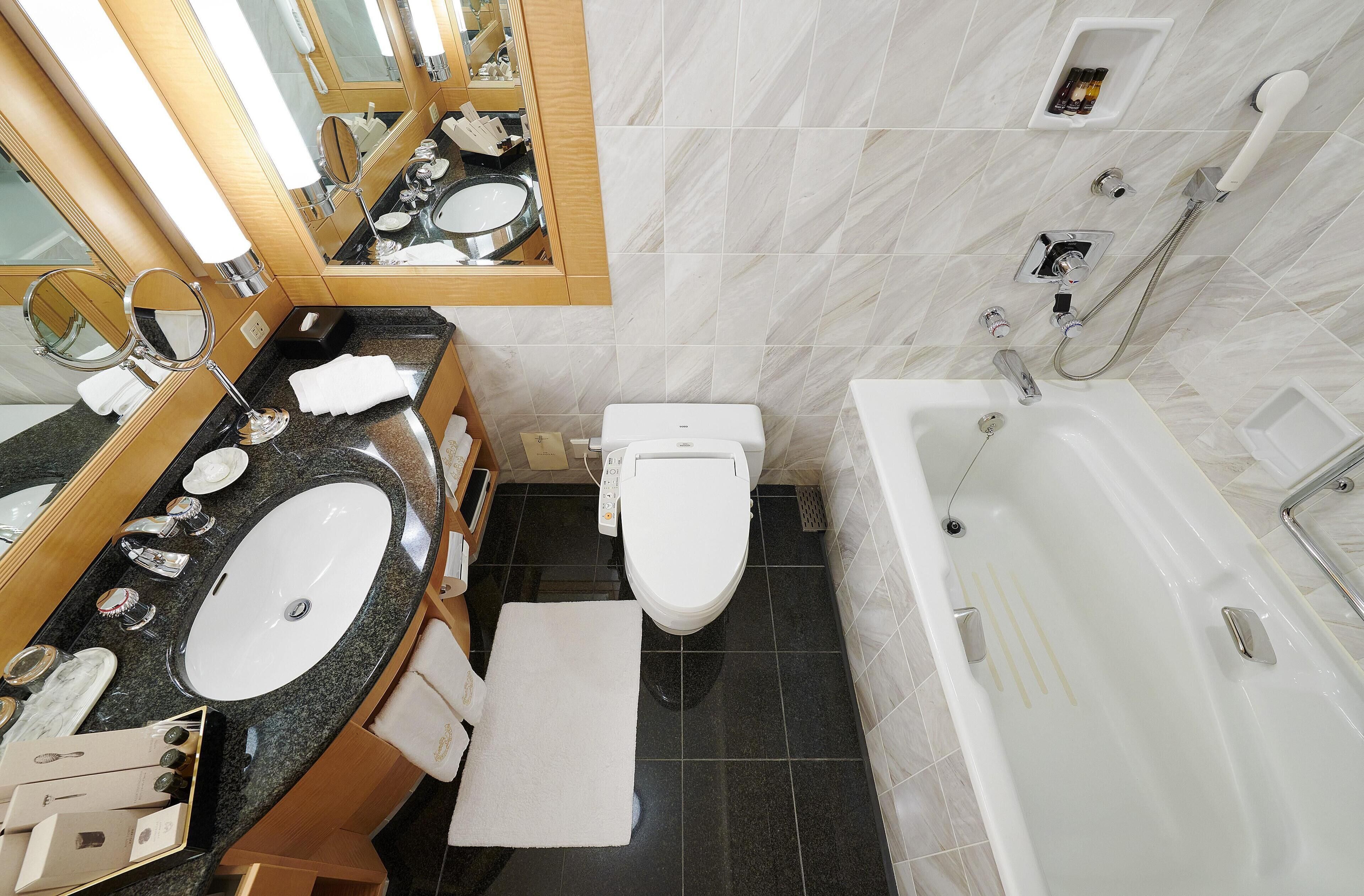 A bathroom with a sink, toilet, and bathtub.
