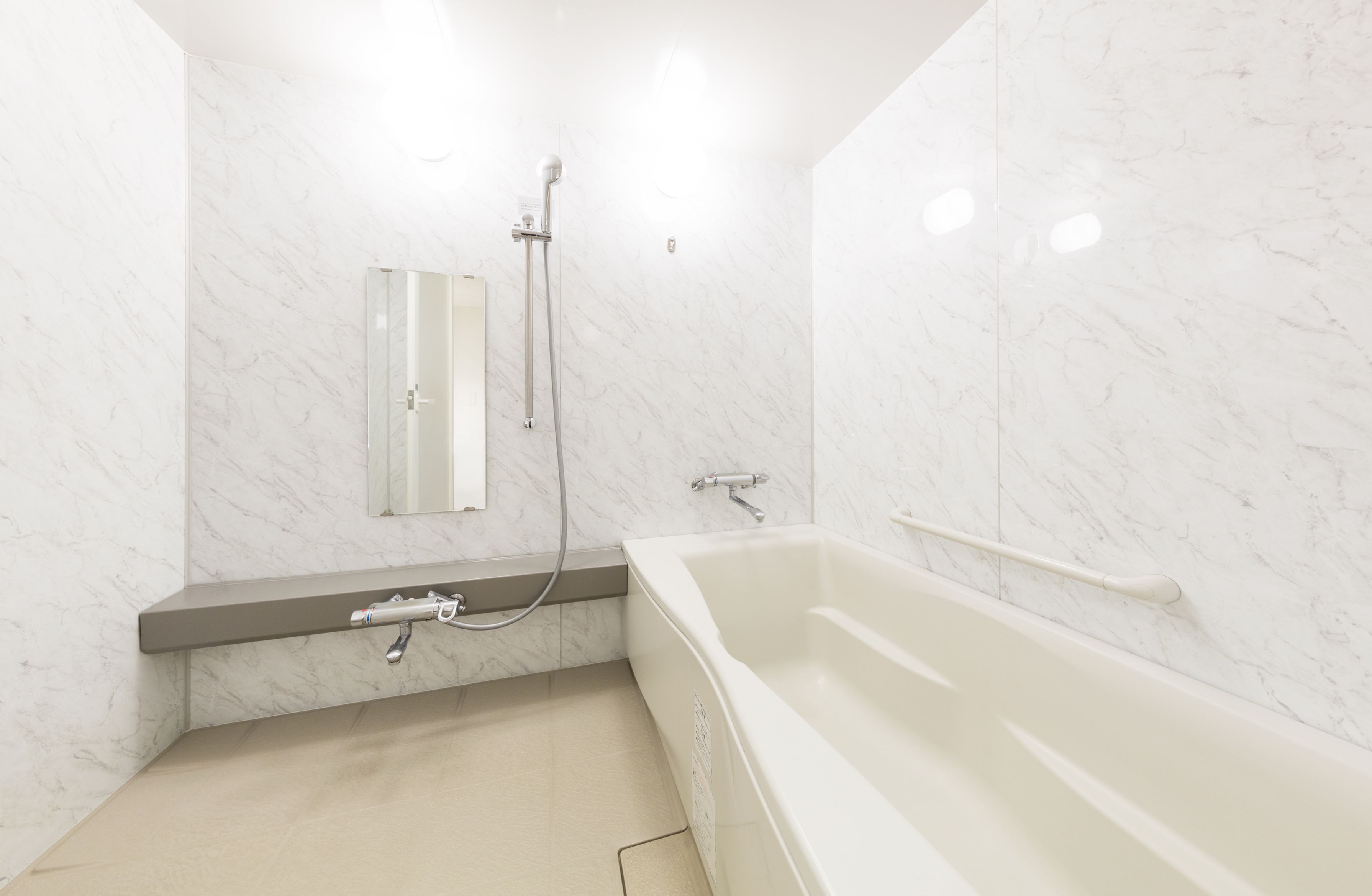 A modern bathroom with a bathtub, a shower, and a vanity with a mirror.