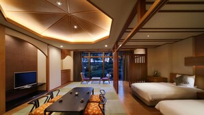 A modern hotel room with a dining table, two beds, a TV, and a view of the outdoors. - Hotel Metropolitan Sendai (Sendai)