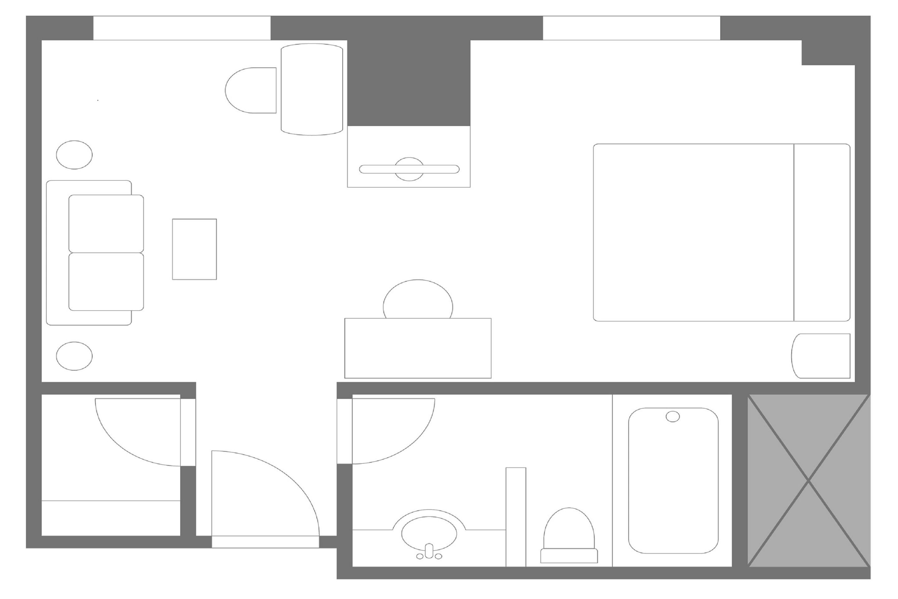 A hotel room layout with a bed, desk, chair, wardrobe, and bathroom.
